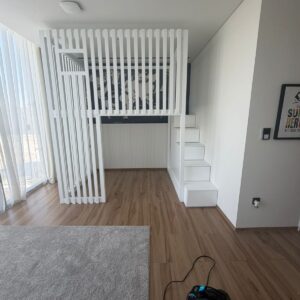 white loft bed with storage staircase and slatted safety rail for kids room