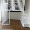 white loft bed with storage staircase and slatted safety rail for kids room