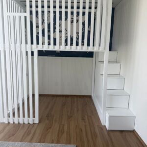 white loft bed with storage staircase and slatted safety rail for kids room